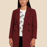 Stilren dobbeltradet damefrakke i uldlook med moderne pasform