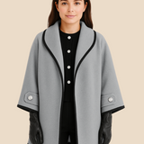 Elegant dameponcho i uldlook med knapdetaljer og løs pasform