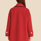 Elegant dameponcho i uldlook med knapdetaljer og løs pasform