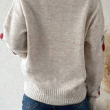 Beige cardigan med kirsebærprint og røde knapper
