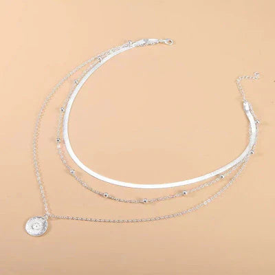 Lagdelte sølvhalskæder med møntvedhæng – elegant og moderne design