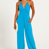 Halterneck dame jumpsuit med dyb udskæring og elastiske ben