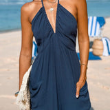 Halterneck dame jumpsuit med dyb udskæring og elastiske ben