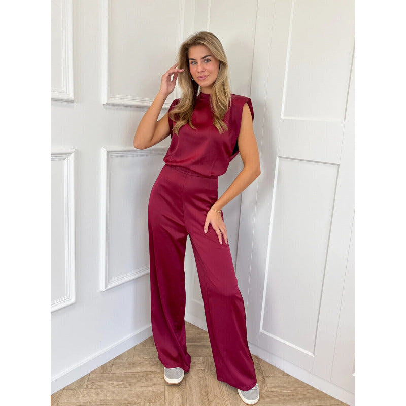 Ærmeløs jumpsuit med skulderpuder og brede satinben