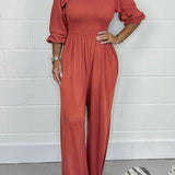 Smocket jumpsuit med firkantet hals og puffærmer