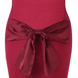 Lang aftenkjole med åben ryg og sløjfe