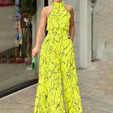 Halterneck jumpsuit med vidde ben og abstrakt print