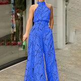 Halterneck jumpsuit med vidde ben og abstrakt print