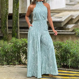 Halterneck jumpsuit med vidde ben og abstrakt print