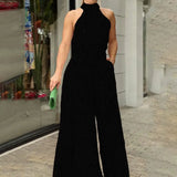 Halterneck jumpsuit med vidde ben og abstrakt print