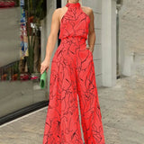 Halterneck jumpsuit med vidde ben og abstrakt print